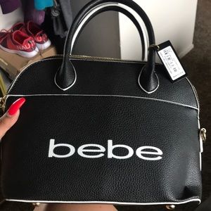 Black and white BEBE purse tags still on it